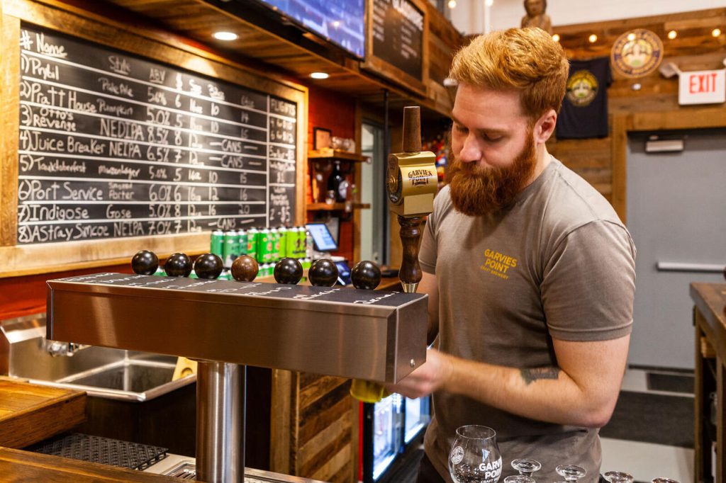 Bartender pouring beer at Garvies Point Craft Brewery