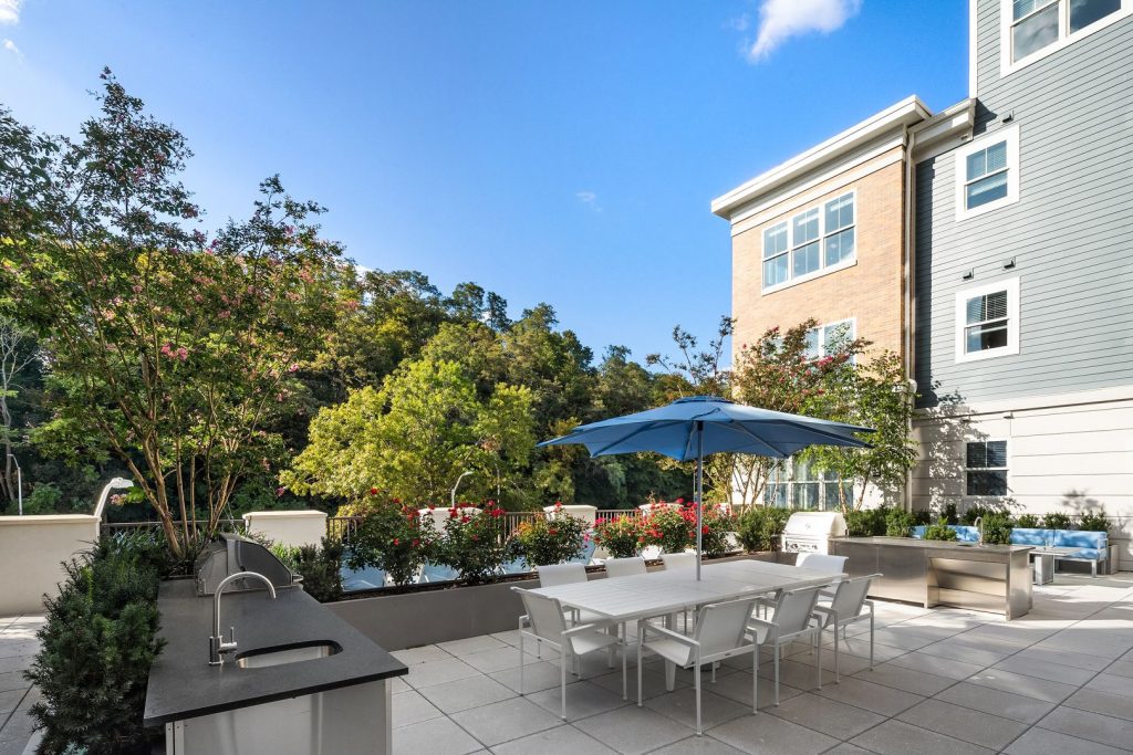 Courtyard with grills and umbrellas.