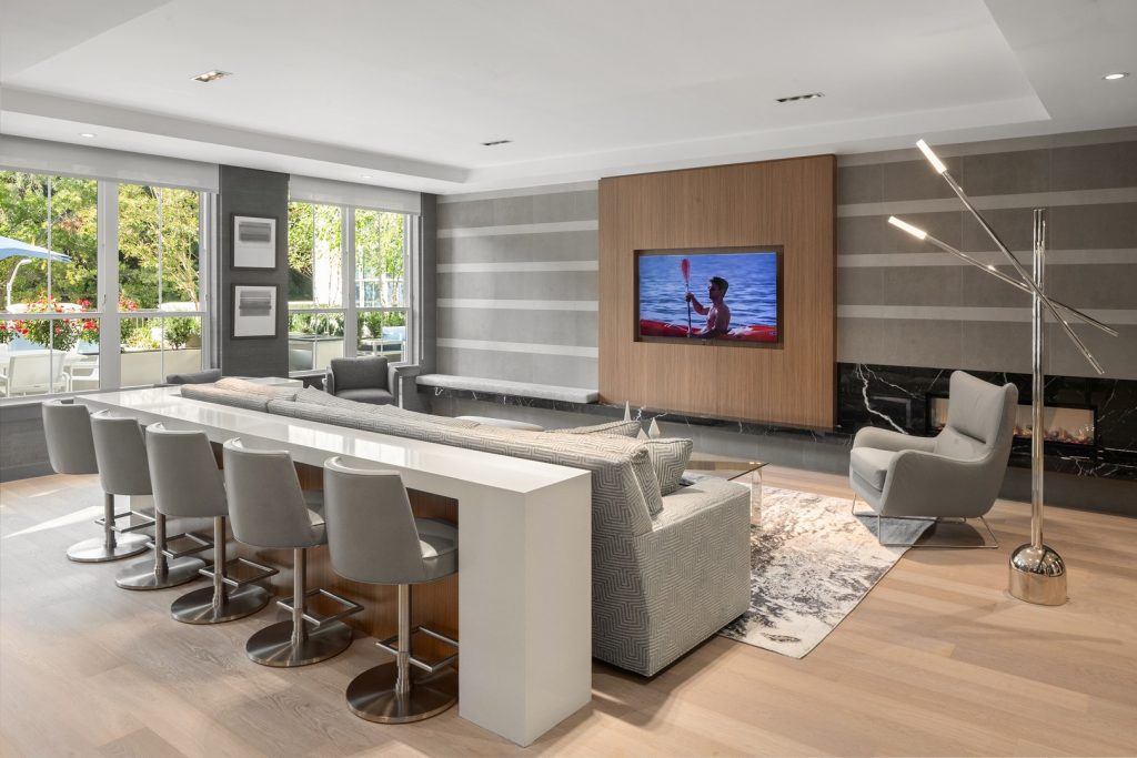 Game lounge with TV and bar seating.